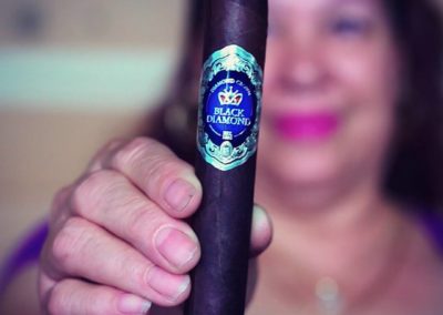 Woman's Hand Holding Black Diamond Cigar