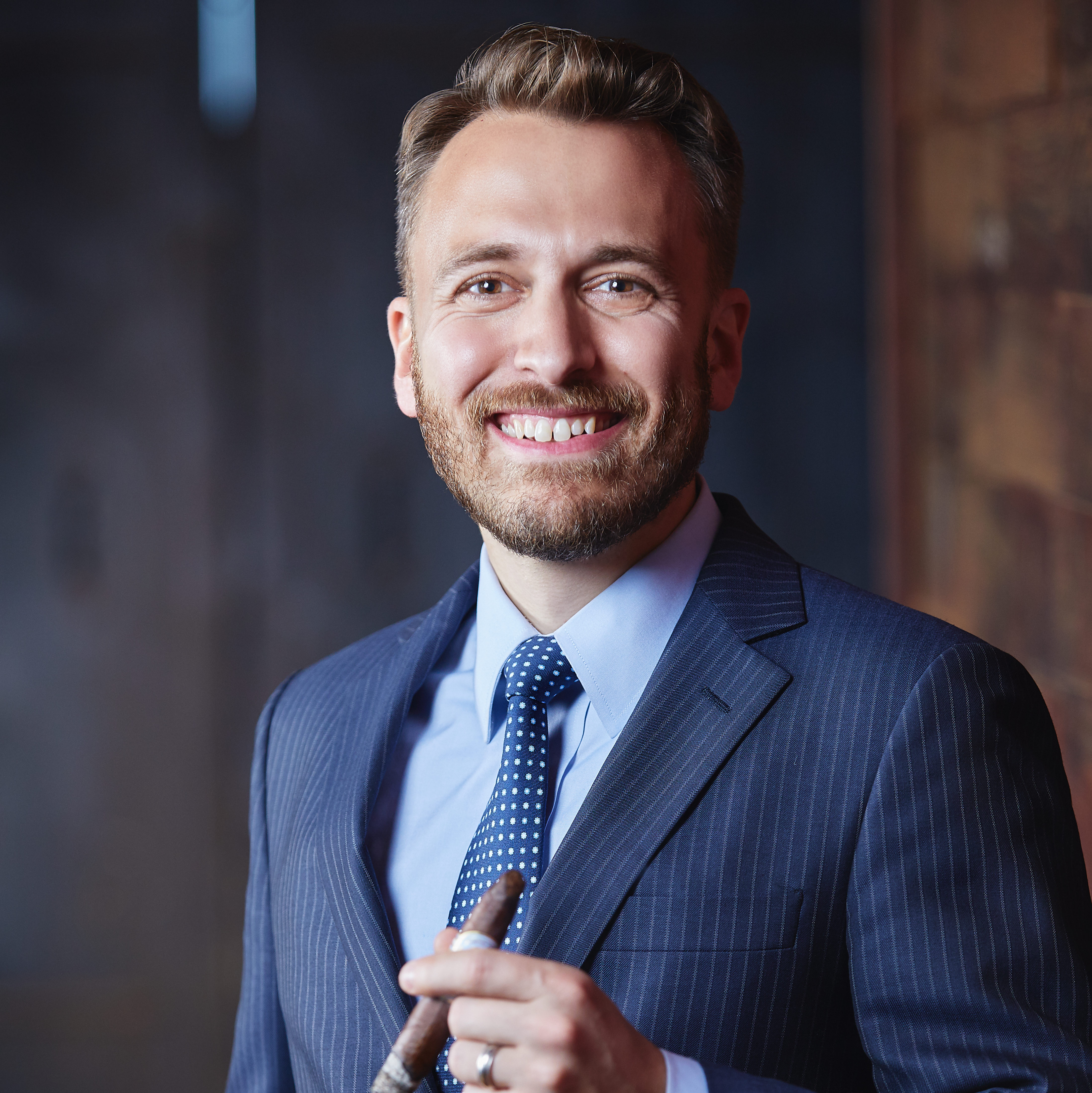 Drew Newman Fourth Generation Headshot holding Julius Caeser Cigar