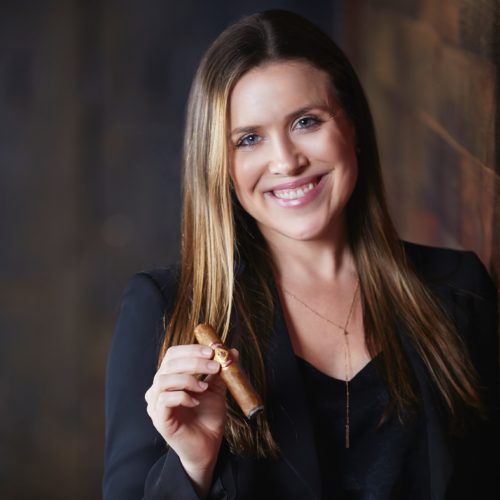 Monica Foster holding Diamond Crown Cigar. Marketing Director Headshot.