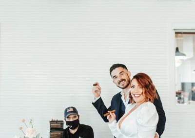 cigar roller at cigar factory wedding with bride and groom