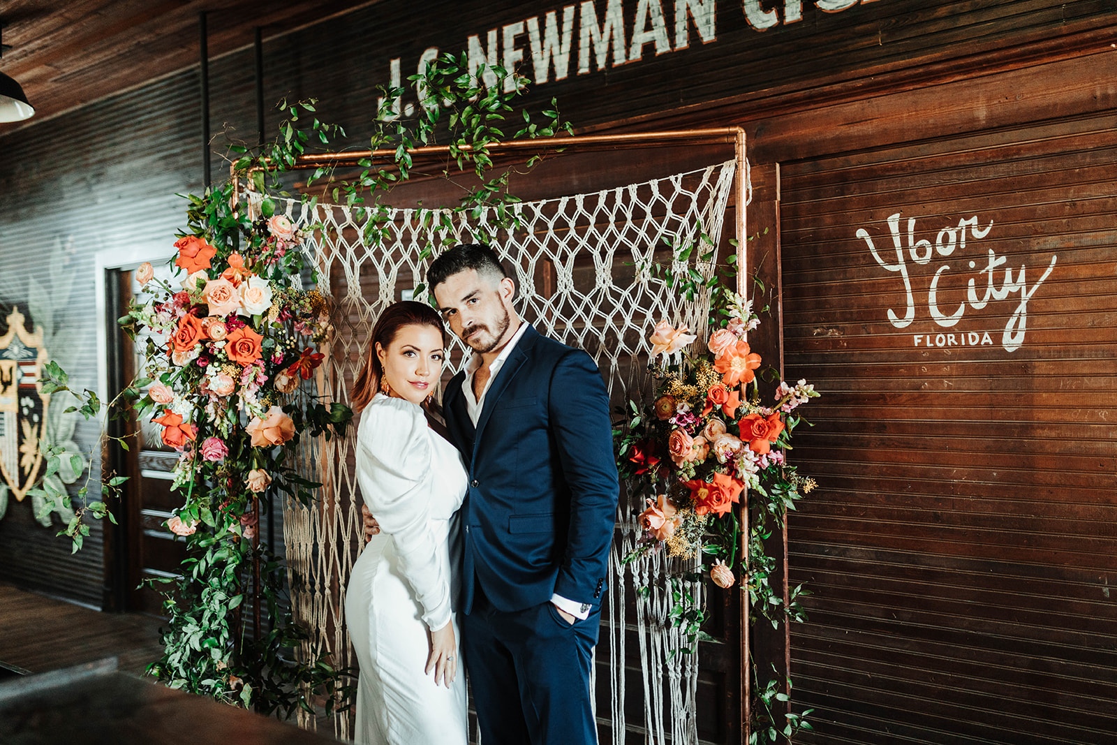 JC NEWMAN bride and groom in cigar handrolling factory tampa