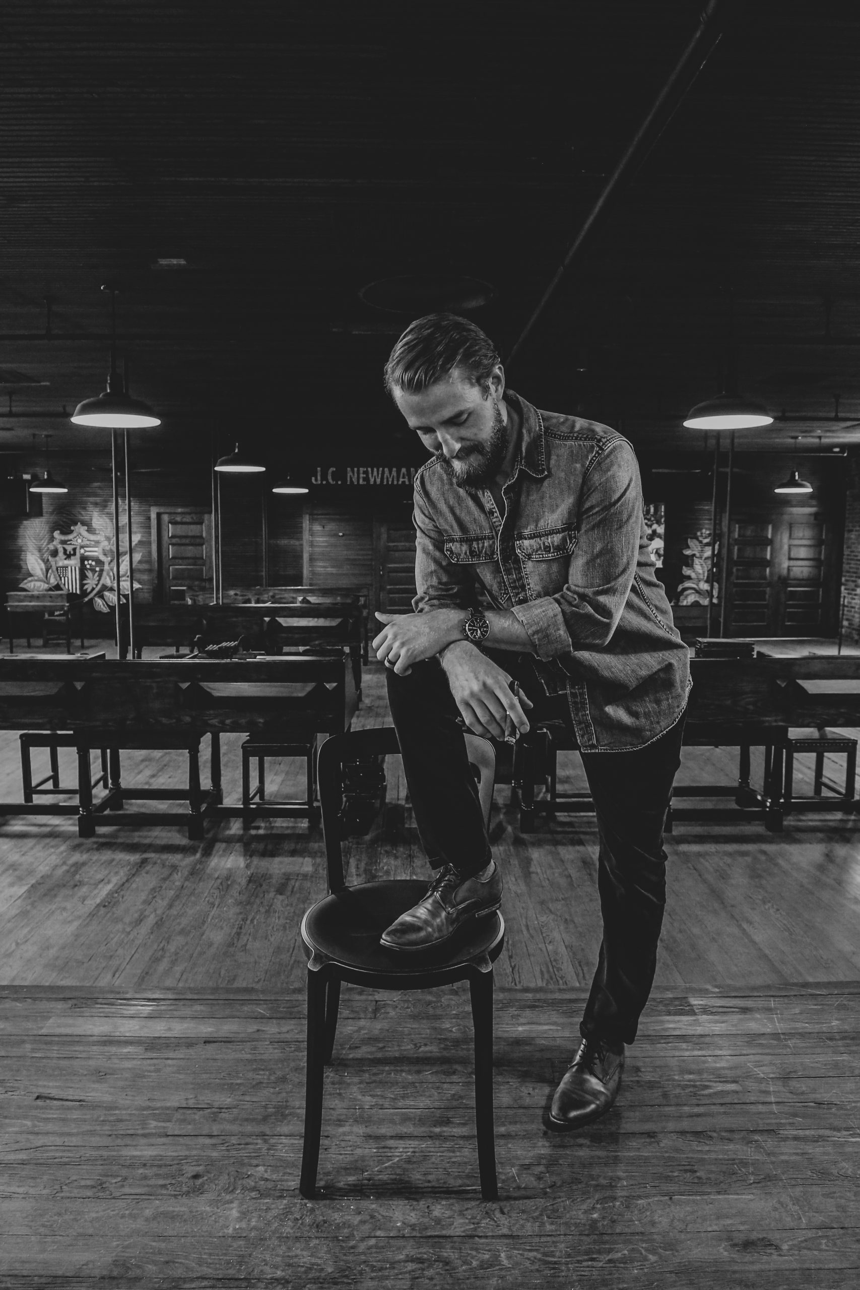 06 man with foot on chair