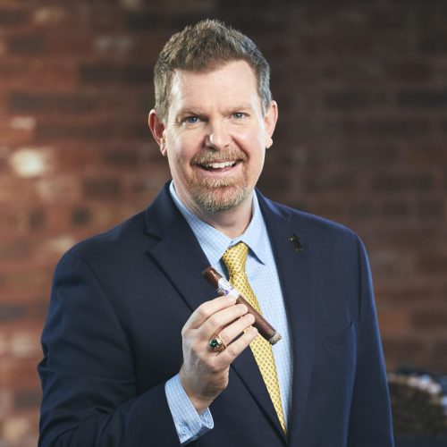michael dougherty sales rep smoking julius caeser cigar headshot
