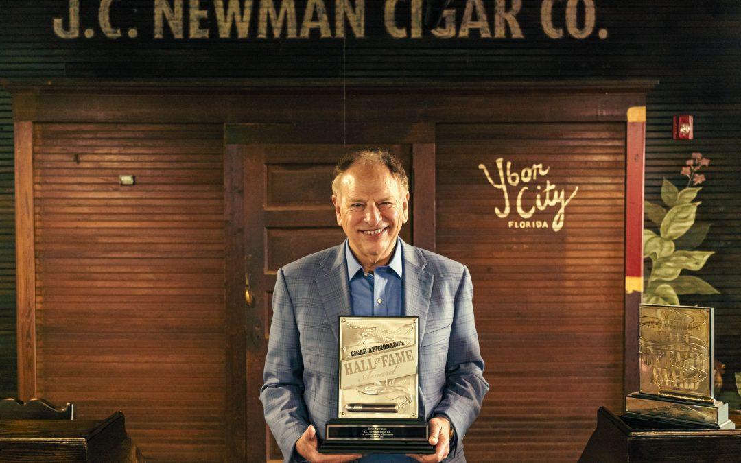 Eric Newman posing with Cigar Aficionado Hall of Fame Award