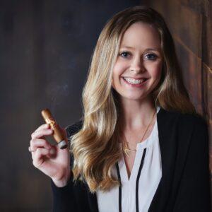 Kara Guagliardo Holding Diamond Crown. Marketing Director Headshot.