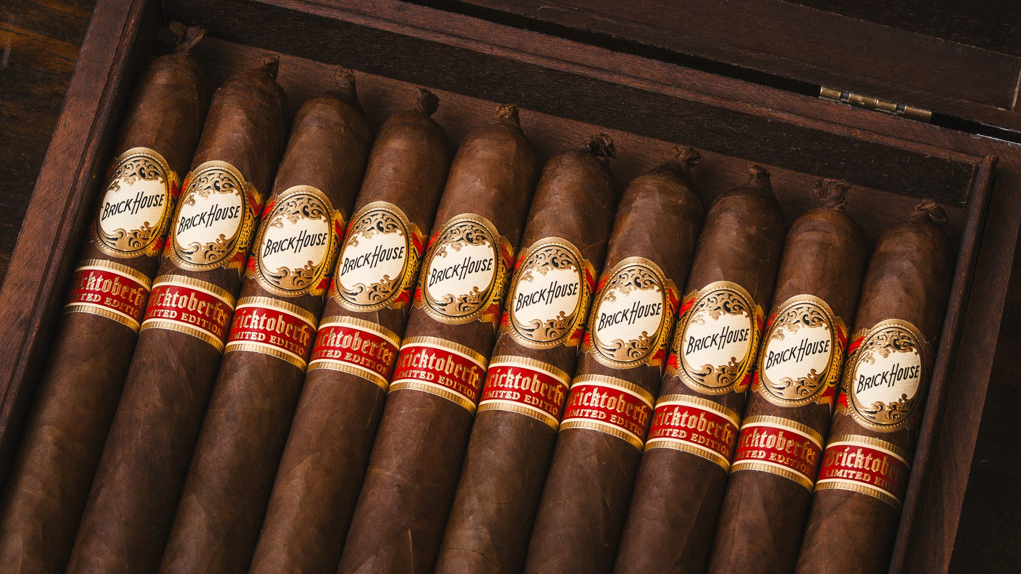 Open box of 10 Brick House Cigars, with the limited edition bricktoberfest secondary band and pigtail top.