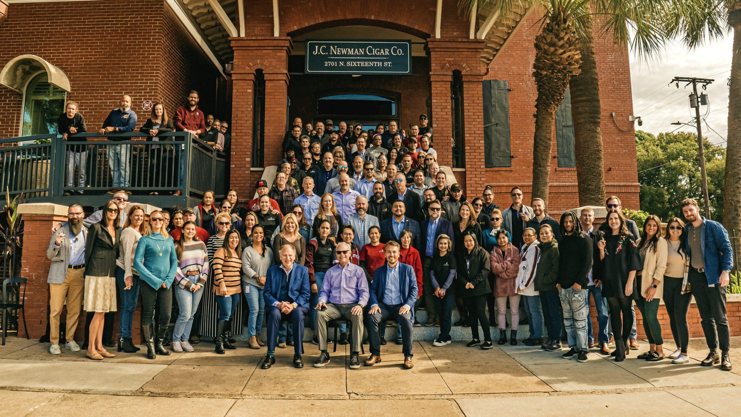 JC Newman employees standing on the steps of the historic cigar factory in Tampa, FL.