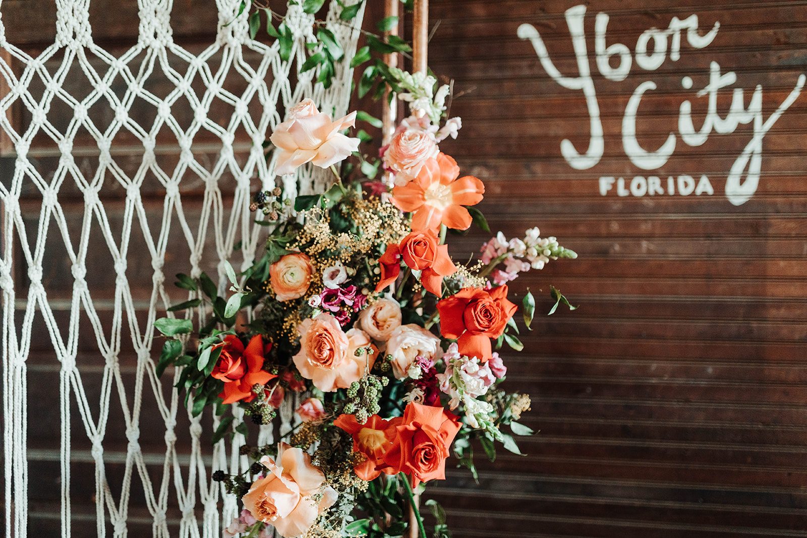 Floral Arrangment in front of an Ybor City Mural inside El Reloj Cigar Factory in Tampa, FL