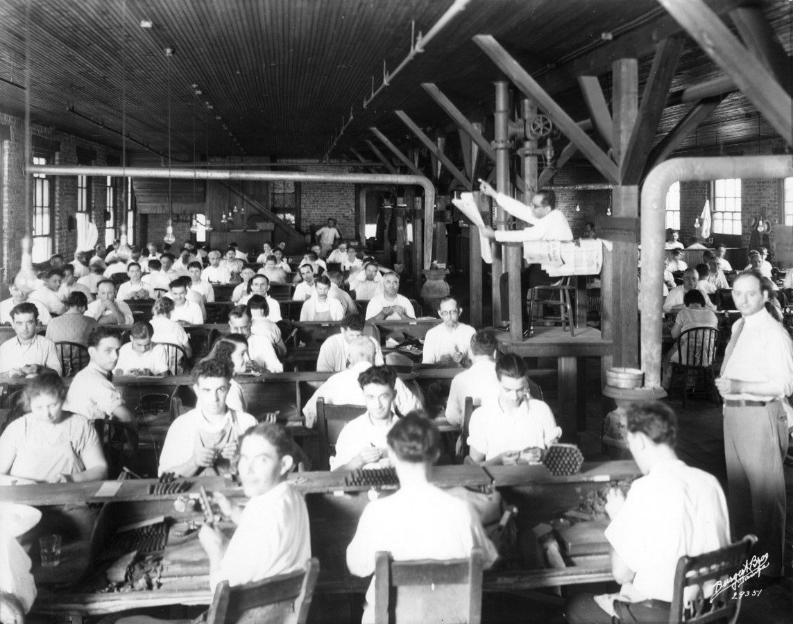 vintage photo in black and white of a cigar rolling floor with a lecturer